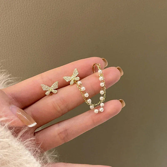 Elegante Schmetterlingsohrringe mit funkelnden Zirkonia und edlen Perlen in Gold